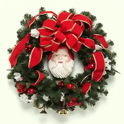 Christmas wreath with red ribbon bow and Santa Claus face decoration