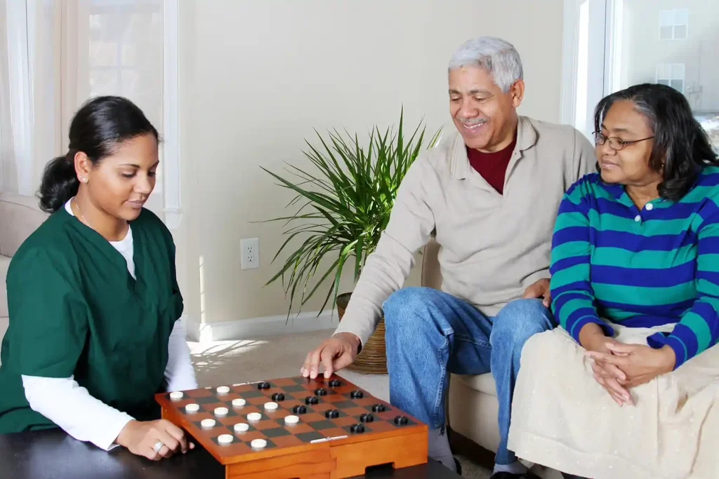 Care Pro playing strategic board game with senior couple to support brain health in Toronto home